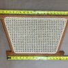 A wooden frame with a white plastic mesh on it.