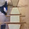 A person is standing on stairs with some kind of grate