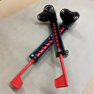 Two red and black poles on a table