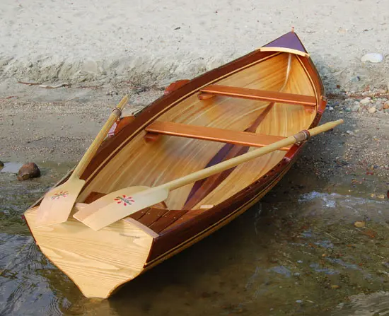 A wooden boat placed by the shore