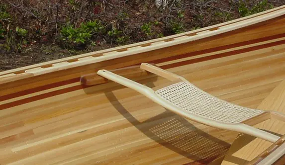 A wooden Contour Canoe Bow Seat in position