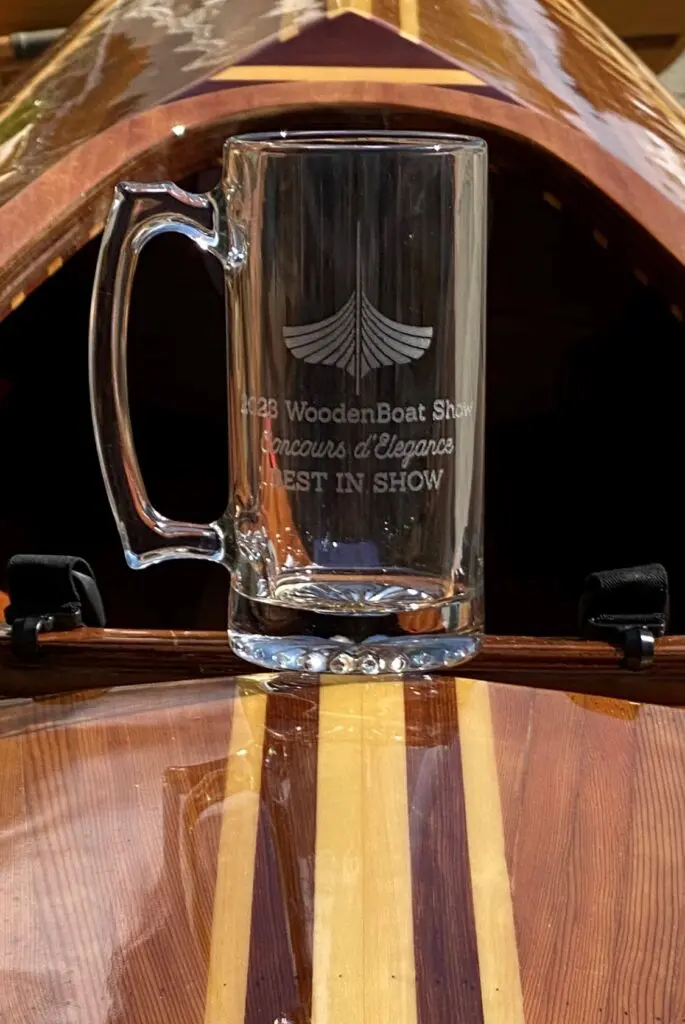 A beer mug sitting on top of a wooden barrel.