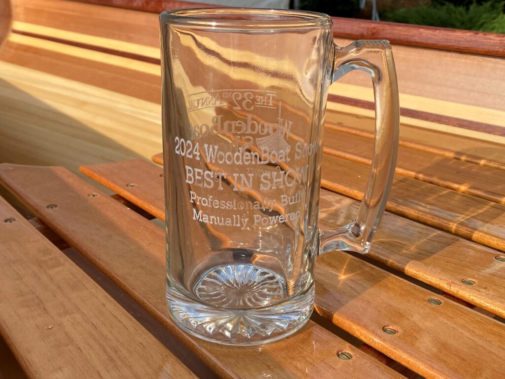 A glass mug sitting on top of a wooden table.