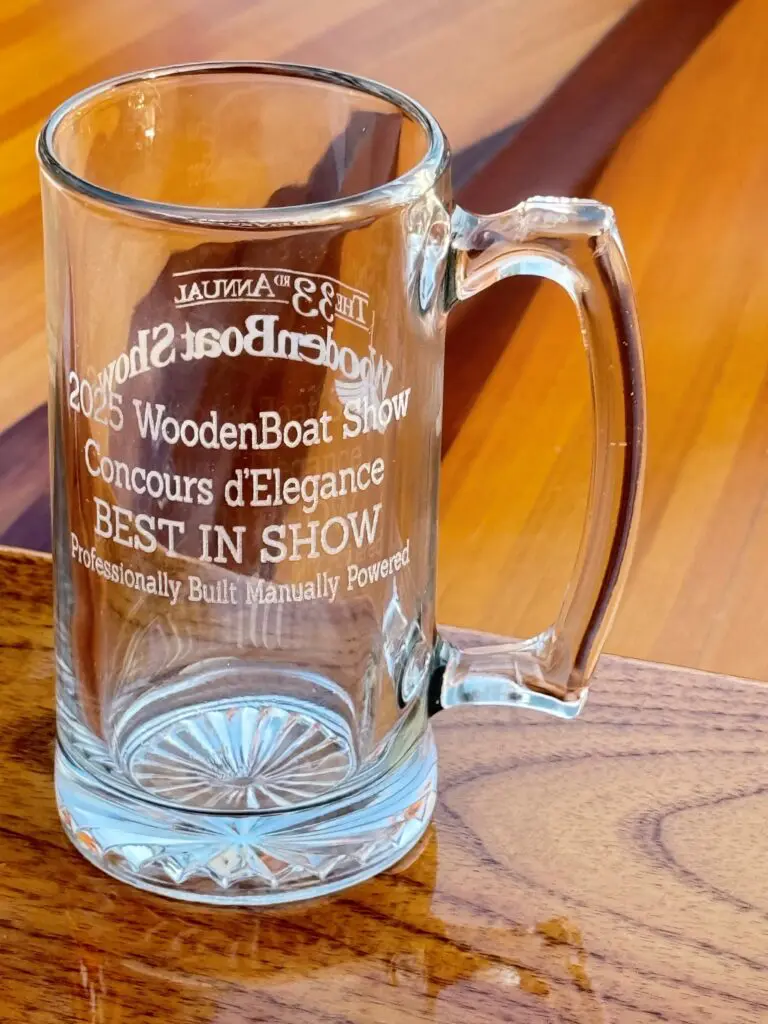 2025 Best in Show: Professionally Built Boat won by Newfound Woodworks: Cedar Strip 15' Sporting Rowboat "Rangeley" at the WoodenBoat Show in Mystic, CT.