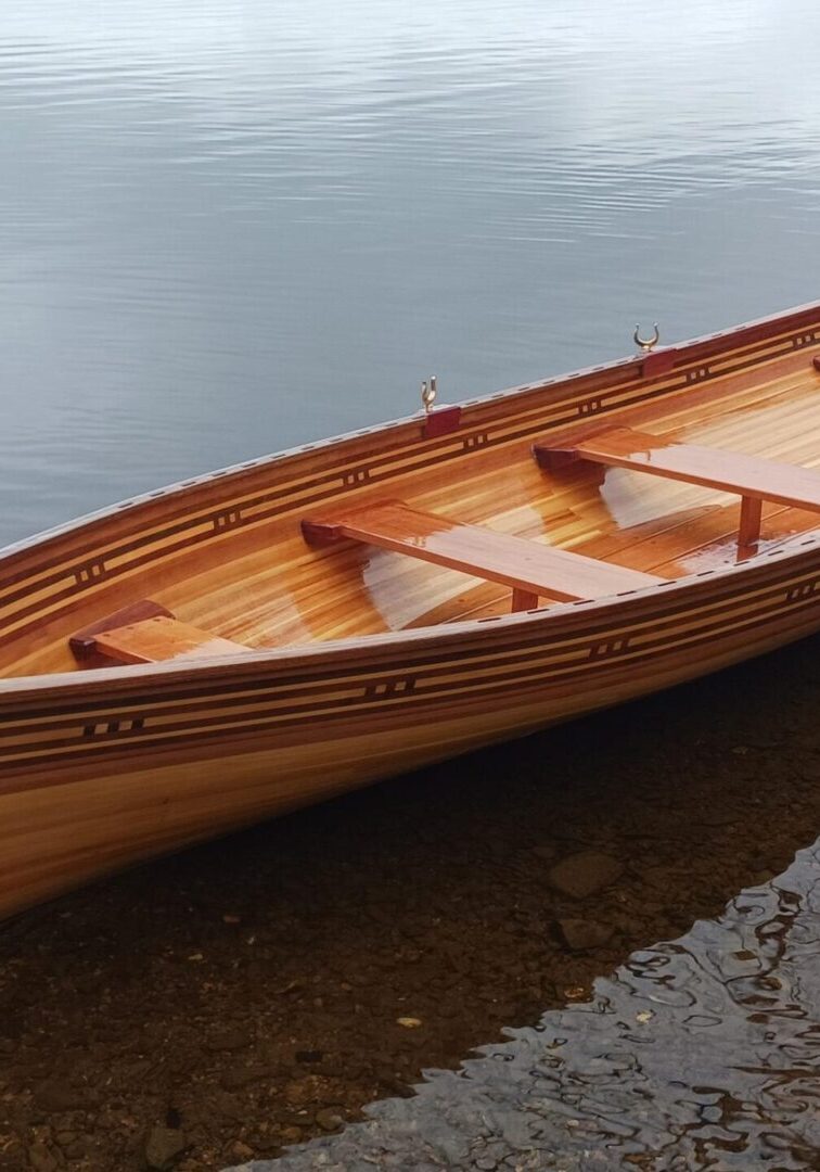 A wooden boat is sitting in the water.