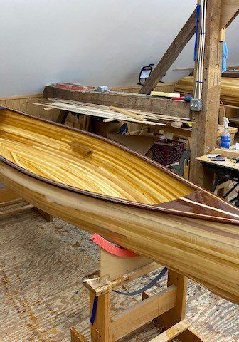 A wooden boat sitting on top of a table.